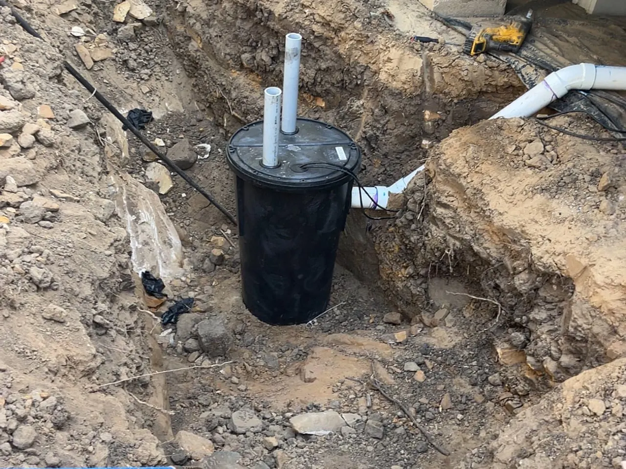 Pump basin and PVC lines dug out beside a home on piers, emergency septic service